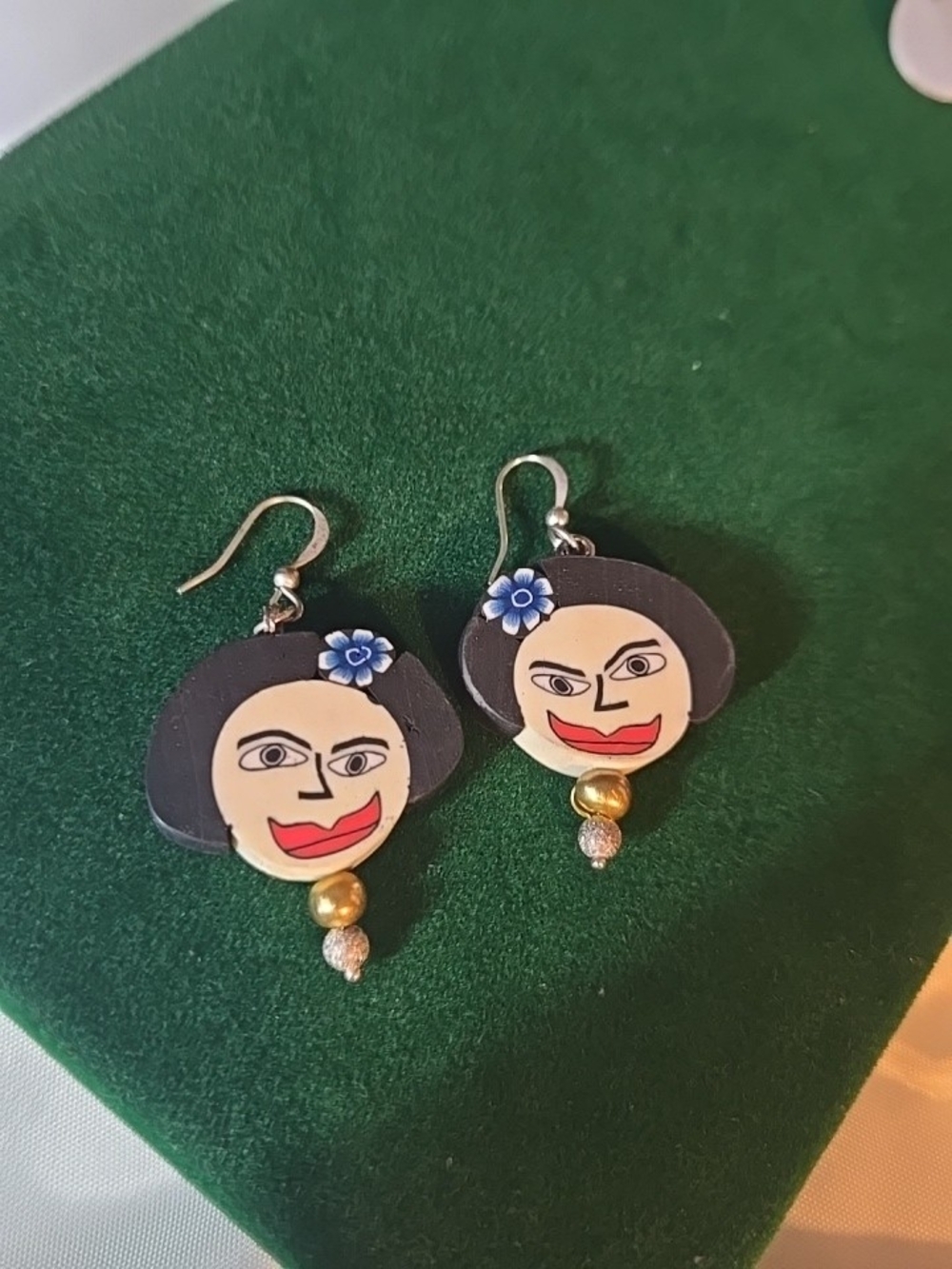 Handcrafted Black and Beige Face Drop Earrings with Blue Flower Accent